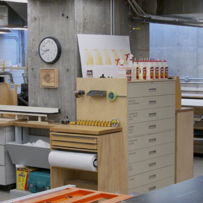 Photo of woodshop, taken across table saw and towards project room.