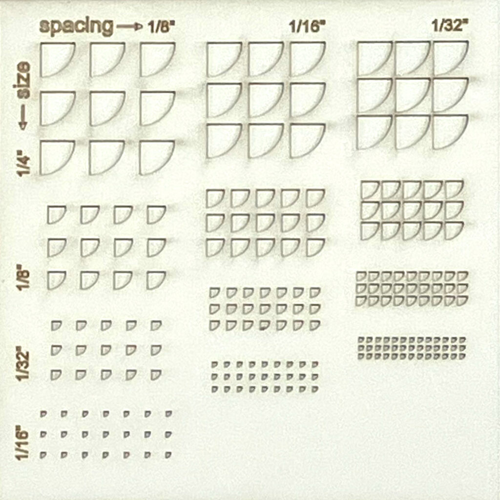 A quarter-circle shape cut in museum board at different sizes and arrayed at decreasing densities.